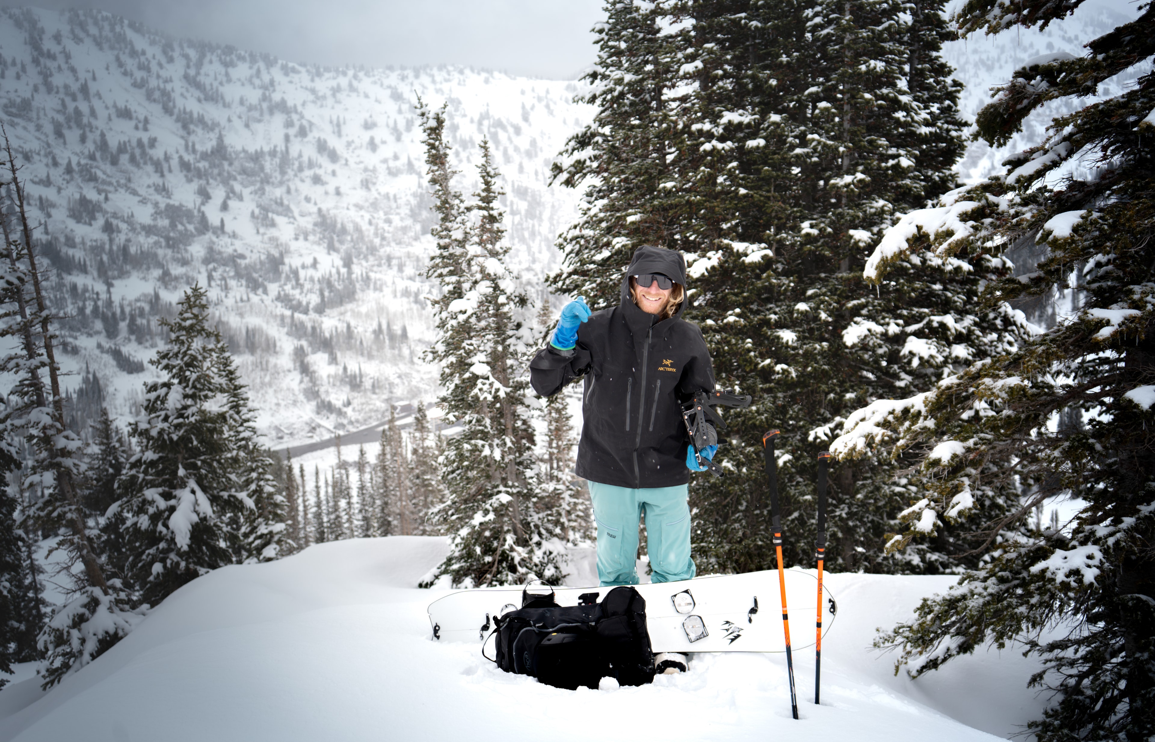 Splitboarder standing with her board and skins in a snowed-in Wasatch bowl